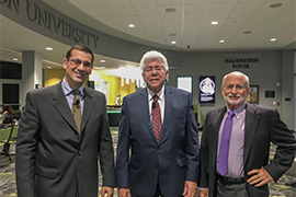 Three men stand side by side in the Rinker Welcome Center lobby.